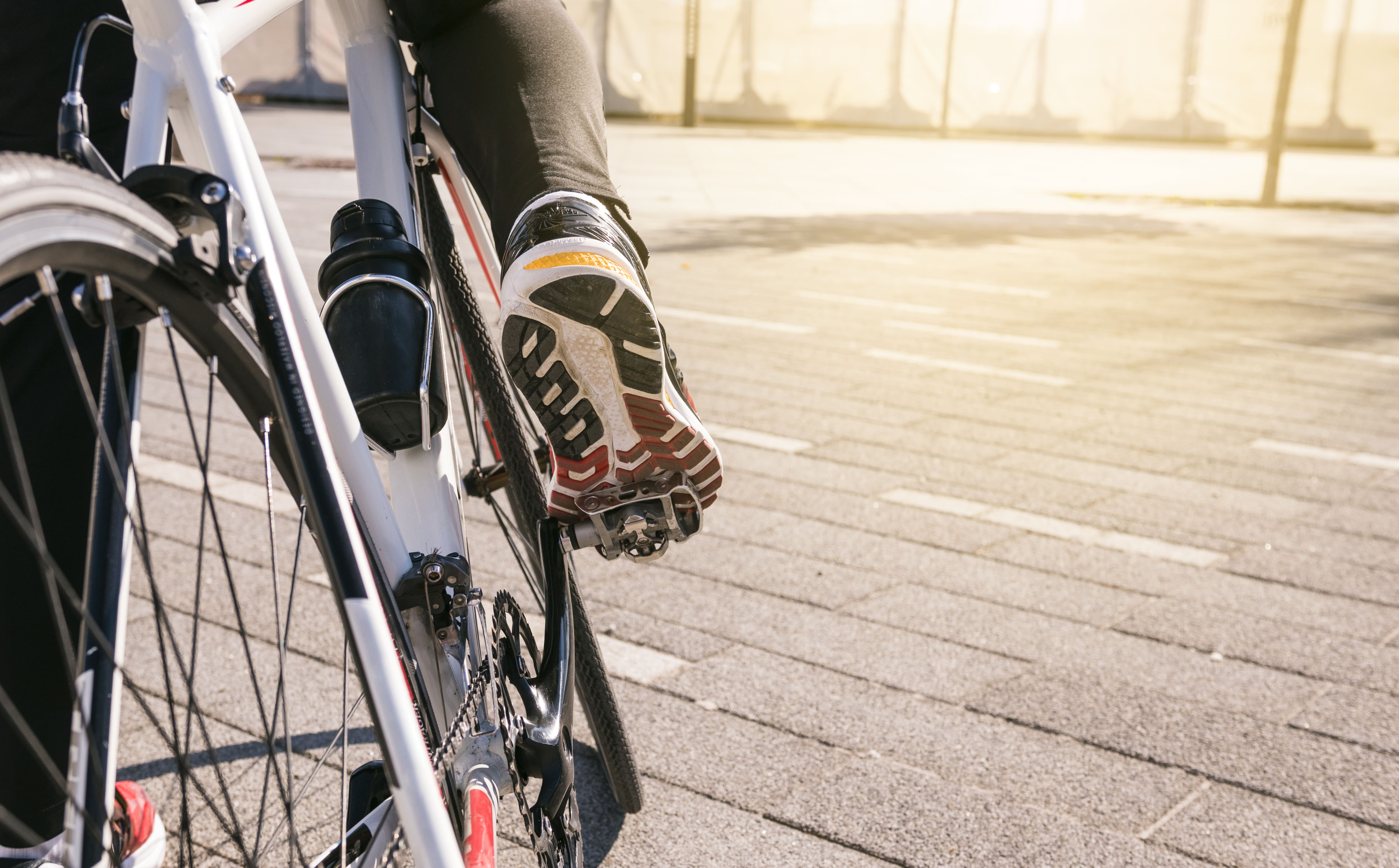 one foot pedals a bicycle